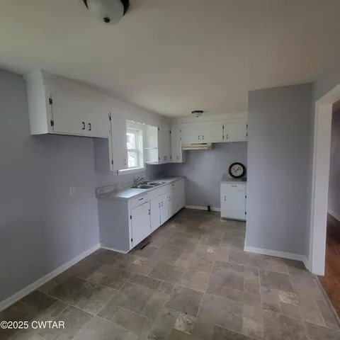a kitchen with a cabinets and window