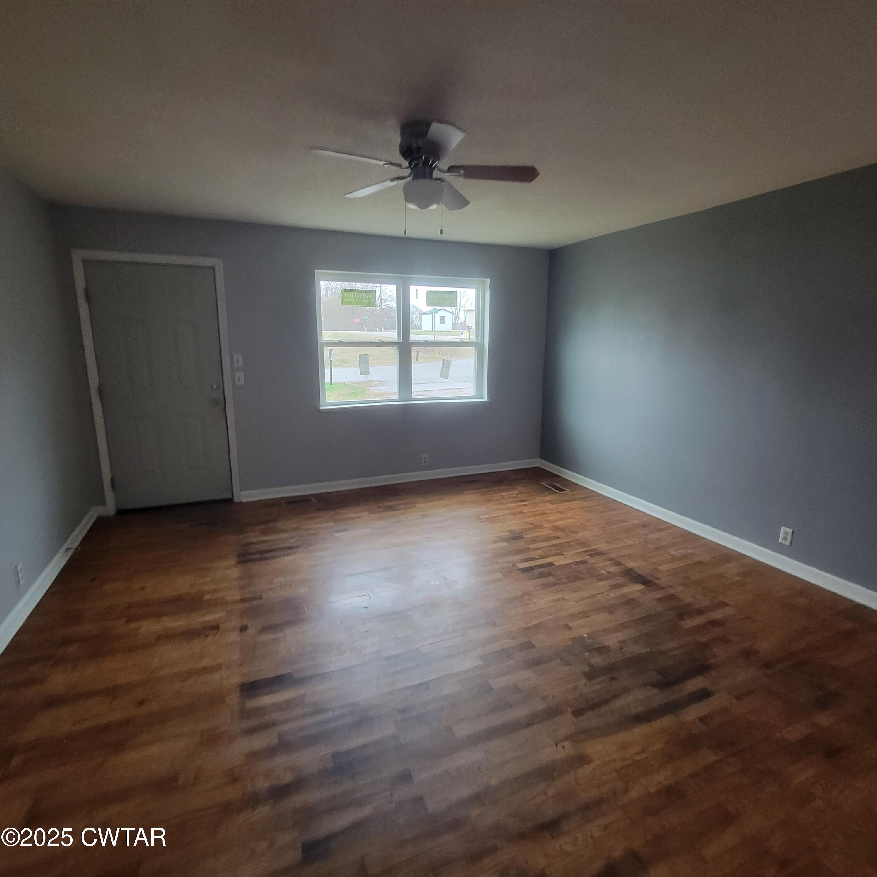 201 Cross Street Rutherford, TN 38369 - Photo 2 of 14 an empty room with wooden floor chandelier fan and windows