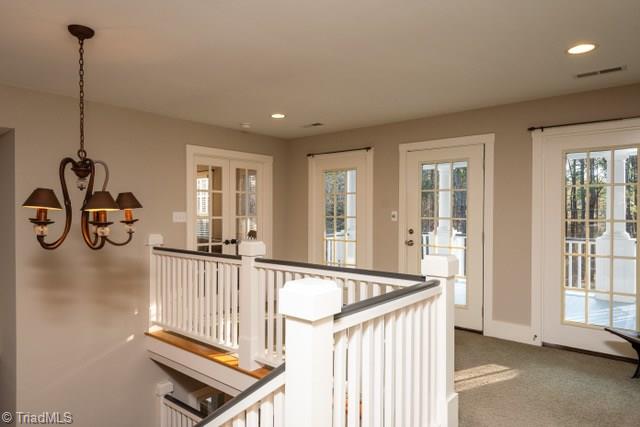 7381 Bullard Road Clemmons, NC 27012 - Photo 18 of 36 Loft area with double doors to nursery and access to 2nd floor covered porch