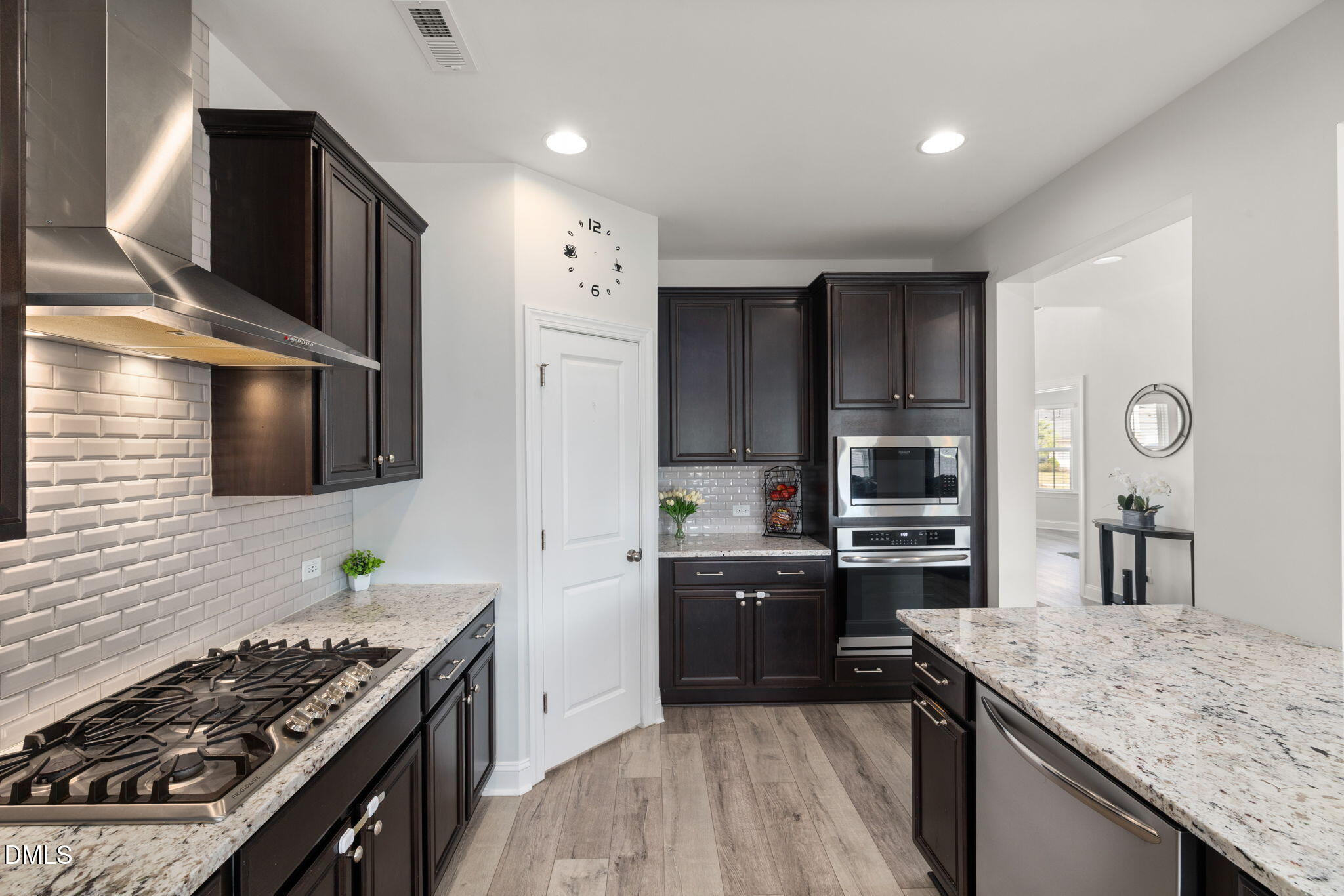 3422 Longleaf Estates Drive Raleigh, NC 27616 - Photo 19 of 71 a kitchen with stainless steel appliances kitchen island granite countertop a stove and a sink