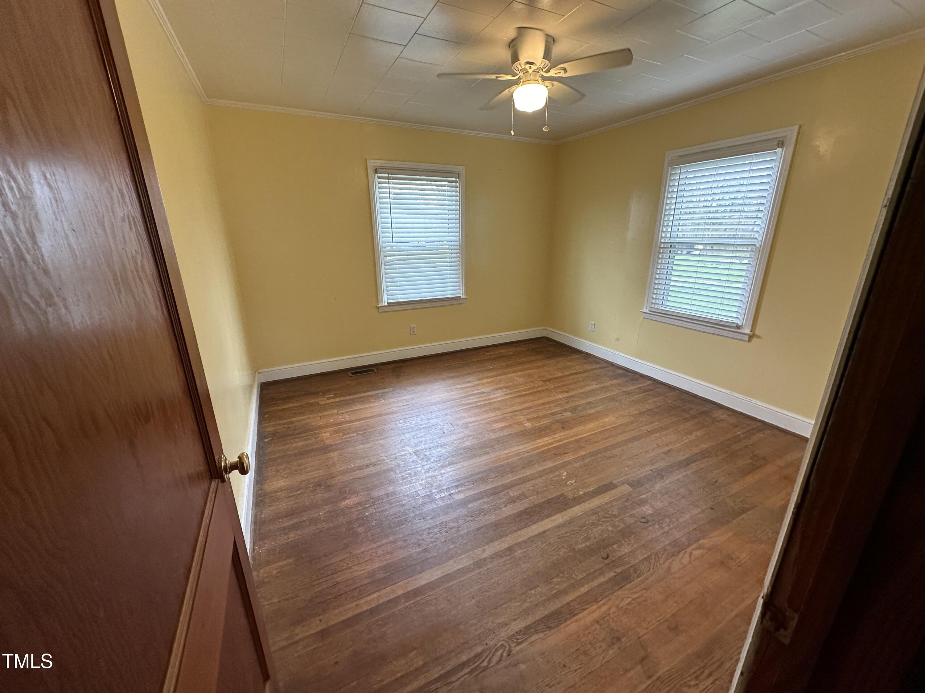 4459 Highway 62 Burlington, NC 27215 - Photo 5 of 27 a view of an empty room with wooden floor and a window