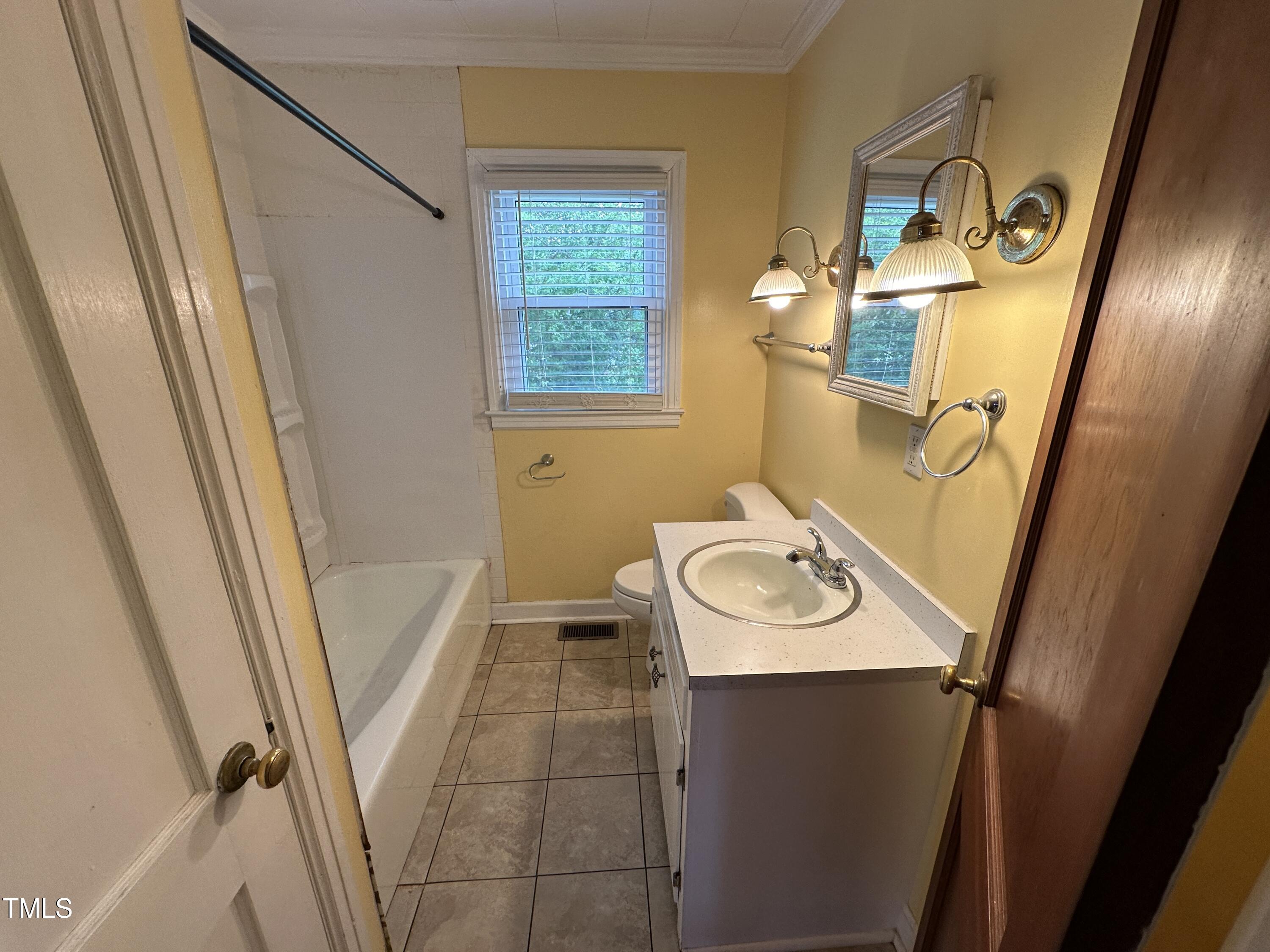 4459 Highway 62 Burlington, NC 27215 - Photo 6 of 27 a bathroom with a sink a mirror and a shower