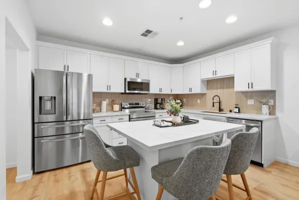 a kitchen with a refrigerator a stove a sink and a refrigerator