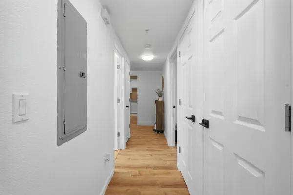 a view of a hallway with wooden floor and staircase