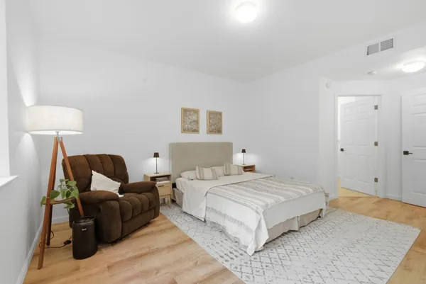 a bedroom with a bed and a lamp