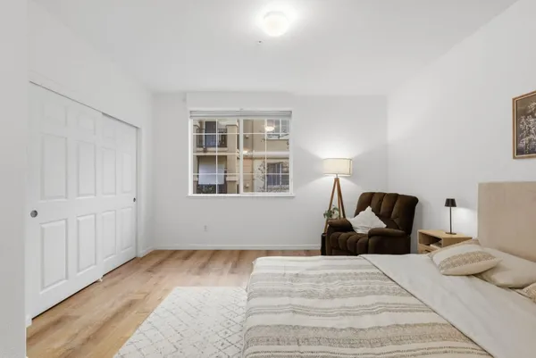 a bedroom with a bed and wooden floor