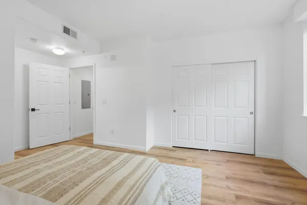 a view of a room with wooden floor