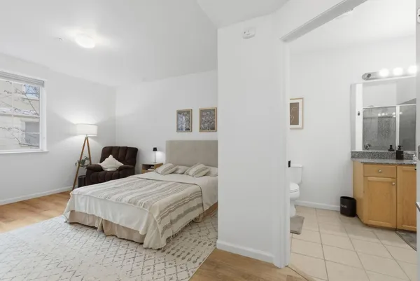 a bedroom with a bed and dresser