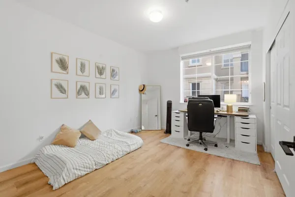 a bedroom with a bed and a desk
