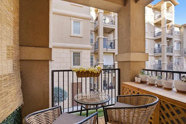 a view of a chair and table in the balcony
