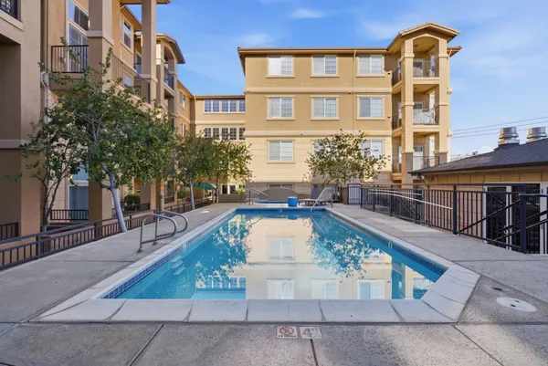 a view of outdoor sitting area with furniture and wooden fence