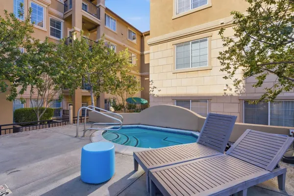 a view of a house with pool and chairs