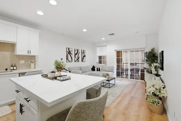 a kitchen with a table chairs stove and cabinets