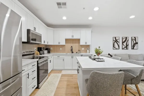 a kitchen with a stove a sink and a refrigerator