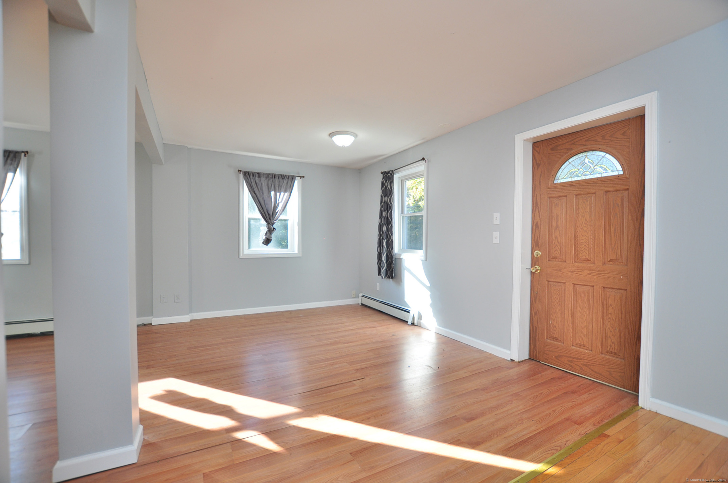15 Clark Hill Road Prospect, CT 06712 - Photo 14 of 35 an empty room with wooden floor and a window