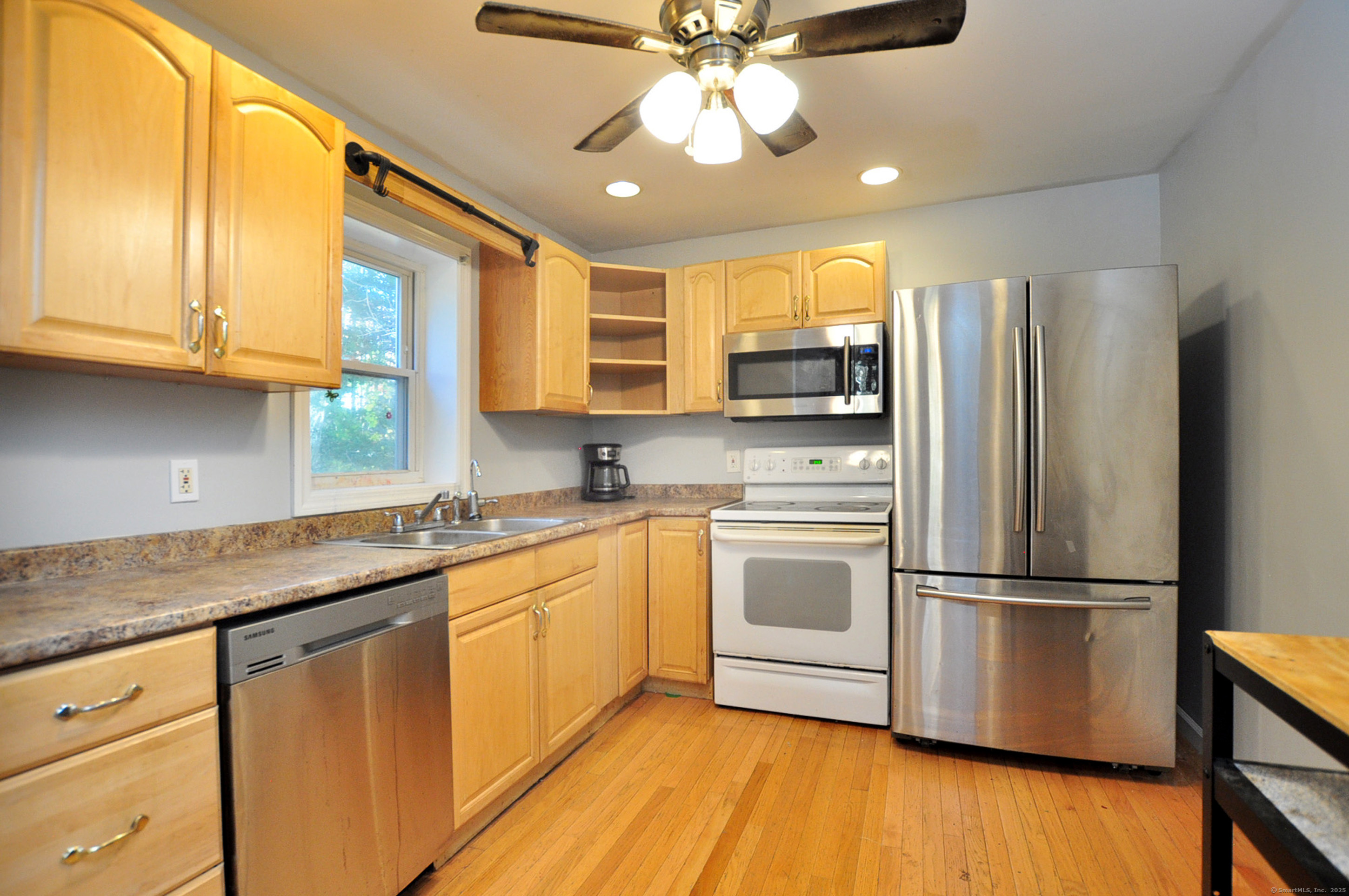 15 Clark Hill Road Prospect, CT 06712 - Photo 18 of 35 a kitchen with stainless steel appliances granite countertop a refrigerator a sink dishwasher a stove and white cabinets with wooden floor