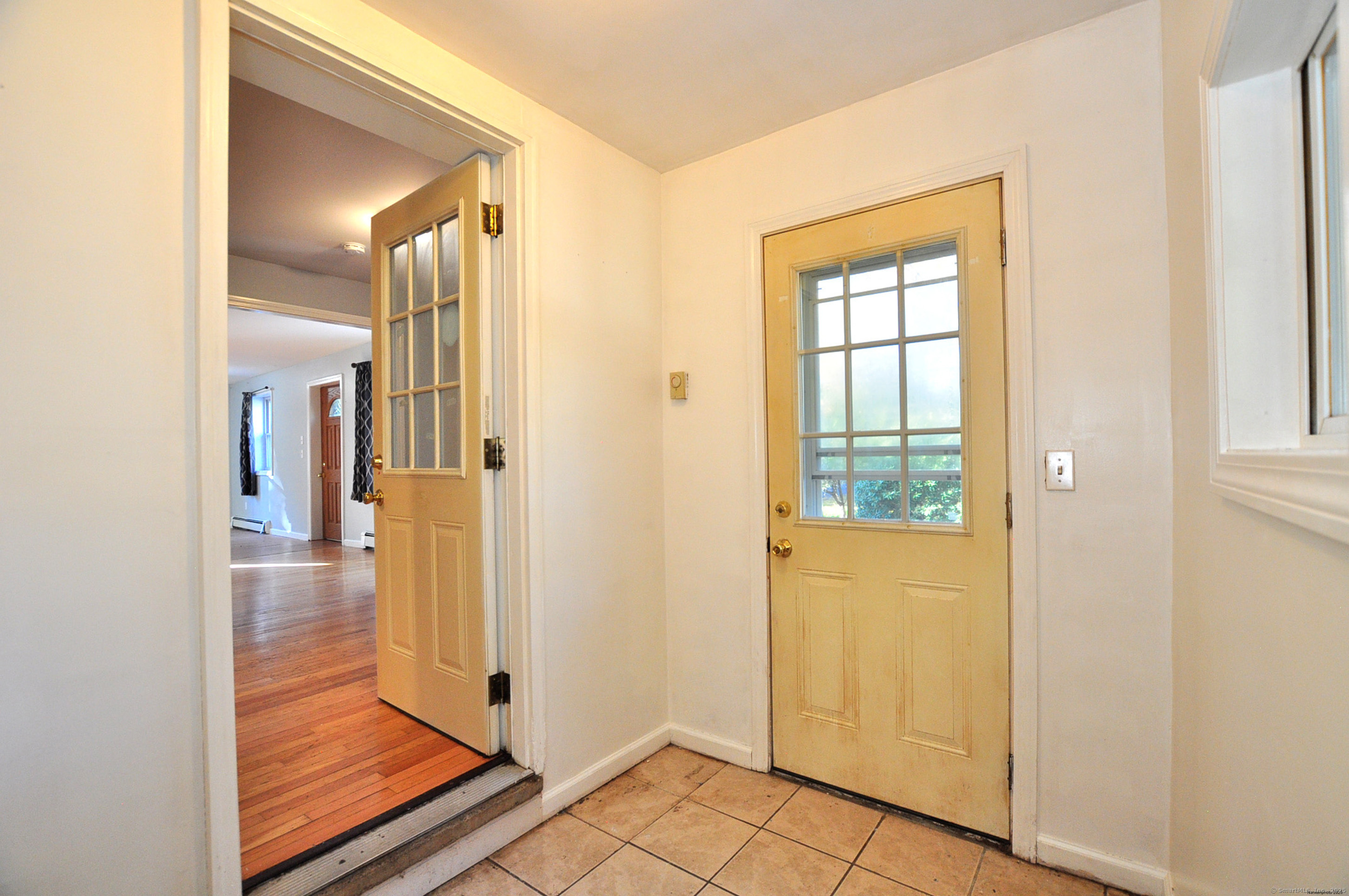 15 Clark Hill Road Prospect, CT 06712 - Photo 20 of 35 a view of a hallway with wooden floor and a living room