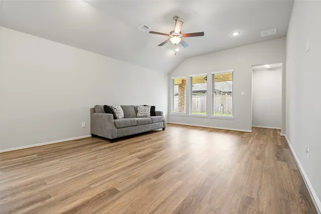 a view of empty room with ceiling fan