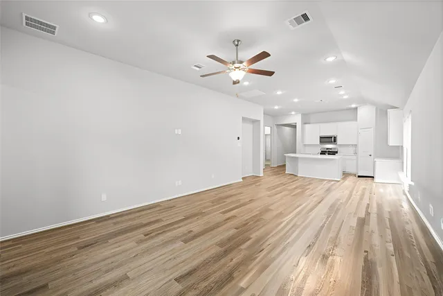 a view of empty room with ceiling fan
