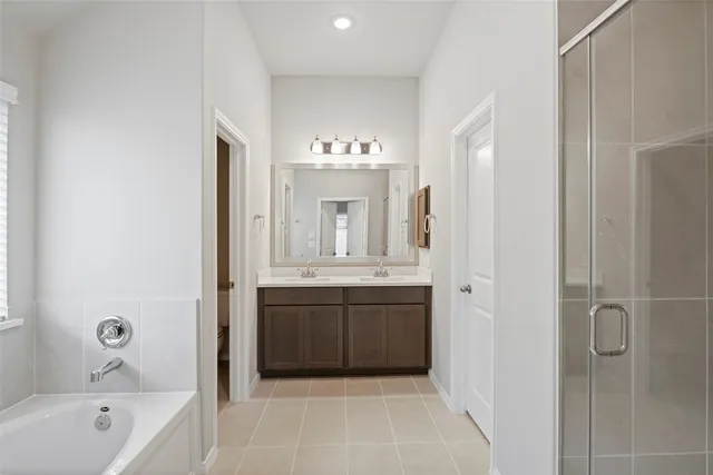 a bathroom with a double vanity sink a mirror and a shower