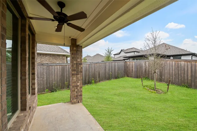 a view of a backyard with table and chairs