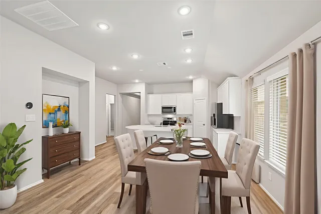 a view of a kitchen with kitchen island a sink wooden floor and a window