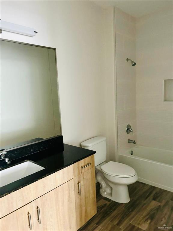 4904 North Crown Point, Unit 1 Pharr, TX 78577 - Photo 22 of 22 a bathroom with a granite countertop toilet and a shower