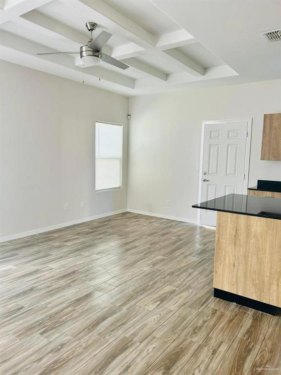 4904 North Crown Point, Unit 1 Pharr, TX 78577 - Photo 9 of 22 an empty room with wooden floor and windows