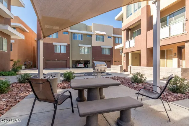 a view of a patio with table and chairs and potted plants