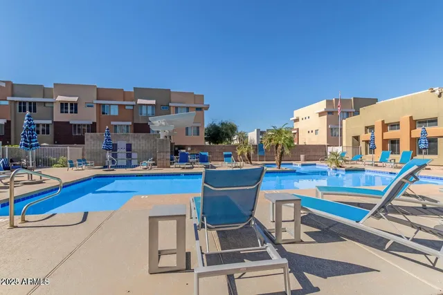 a view of a swimming pool with outdoor seating