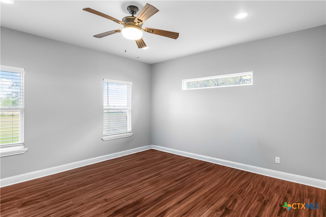 204 James Street Inez, TX 77968 - Photo 15 of 35 wooden floor in an empty room with a window