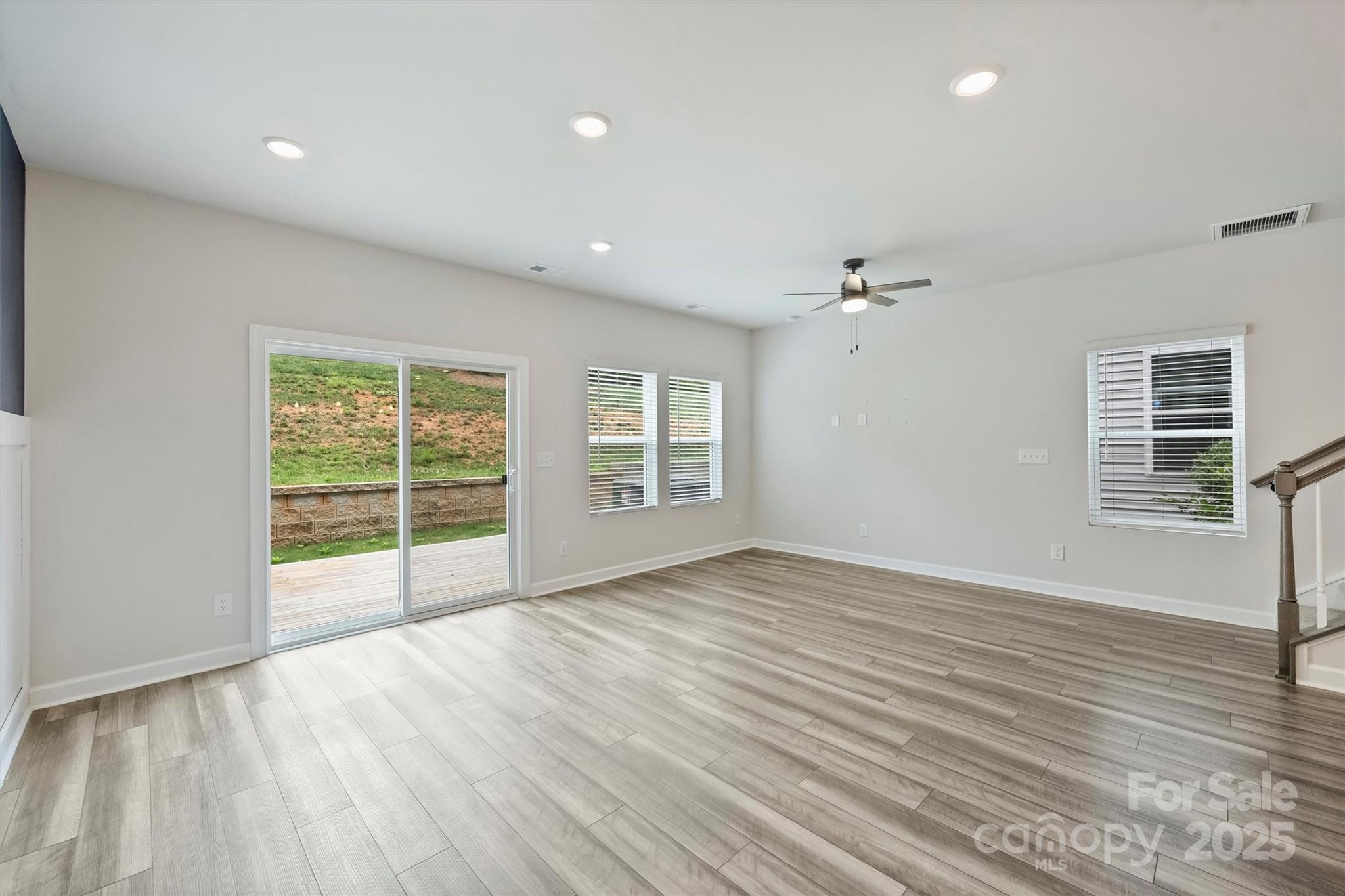 502 Tayberry Lane Fort Mill, SC 29715 - Photo 14 of 39 a view of an empty room with wooden floor and a window