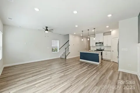 a view of kitchen with wooden floor and electronic appliances