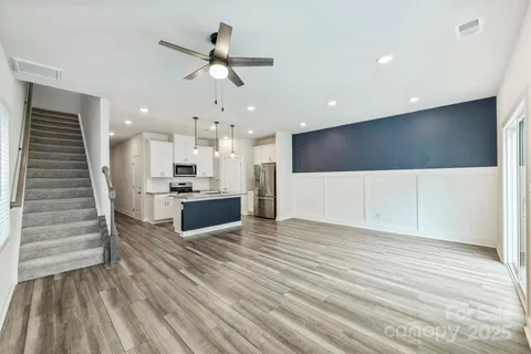 a view of kitchen with cabinets and wooden floor