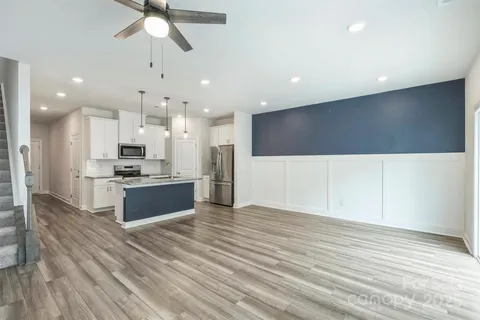 a large kitchen with kitchen island a sink stainless steel appliances and cabinets