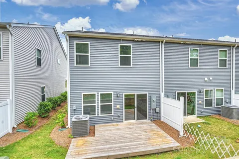 a front view of a house with a yard outdoor seating and garage