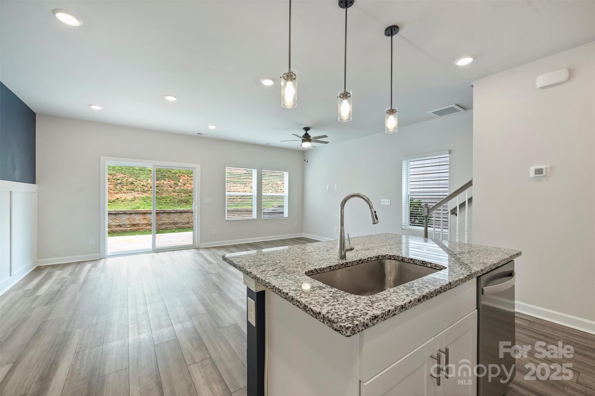 502 Tayberry Lane Fort Mill, SC 29715 - Photo 10 of 39 a kitchen with a sink a faucet a chandelier and wooden floor