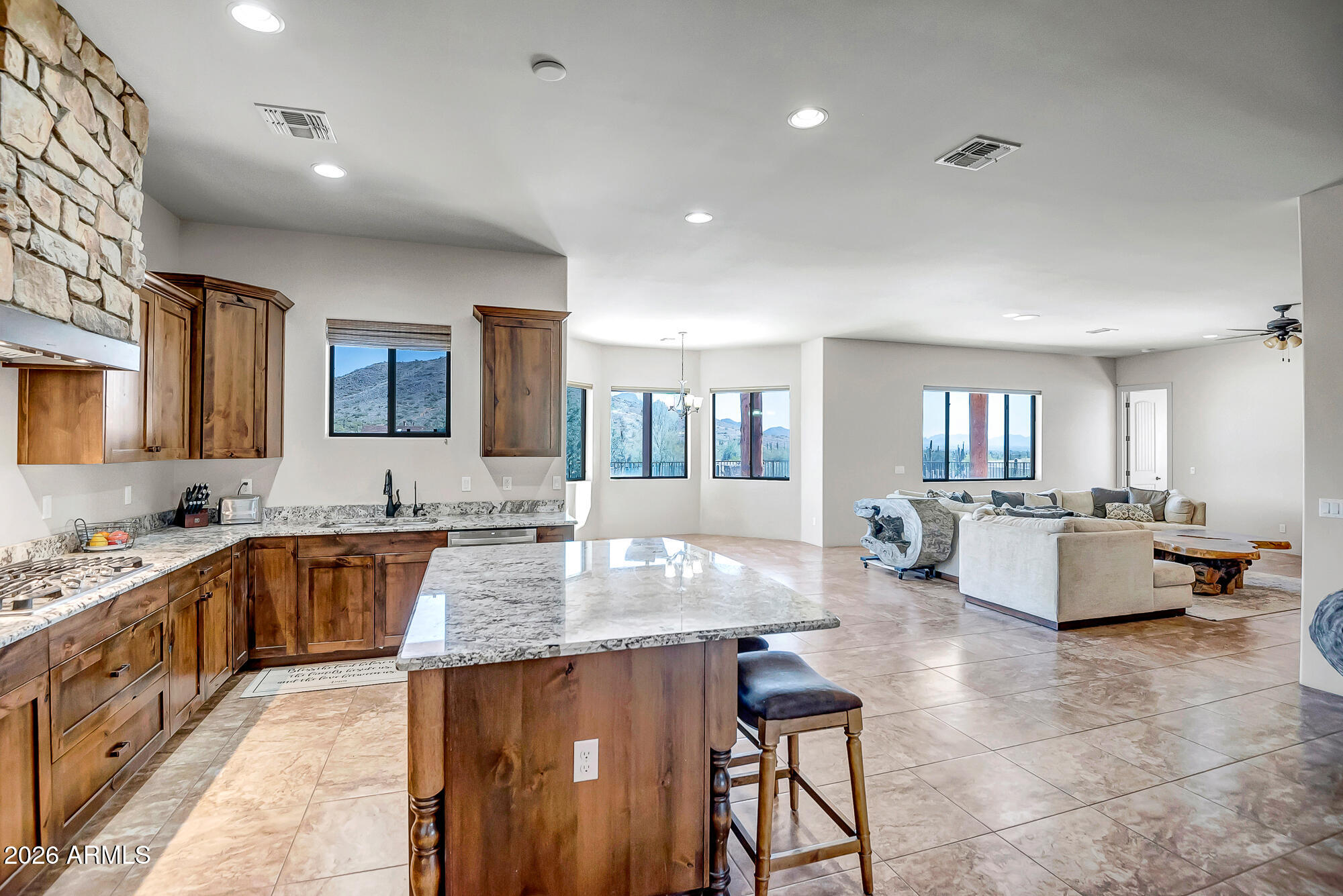 1121 East Saddle Mountain Road Phoenix, AZ 85086 - Photo 11 of 49 a large kitchen with kitchen island a large counter top space and living room