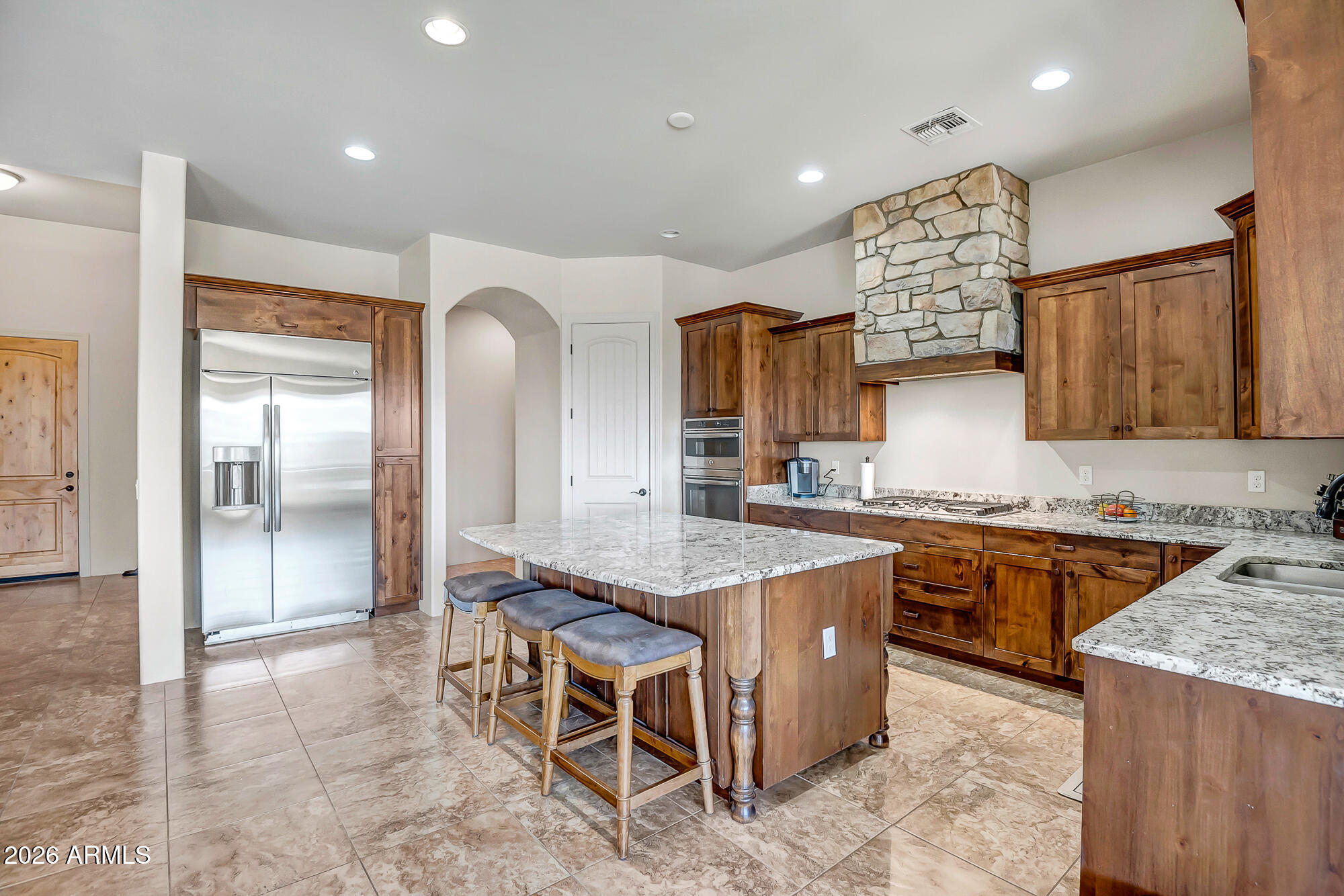1121 East Saddle Mountain Road Phoenix, AZ 85086 - Photo 12 of 49 a kitchen with stainless steel appliances granite countertop a stove top oven a sink a counter top space and cabinets