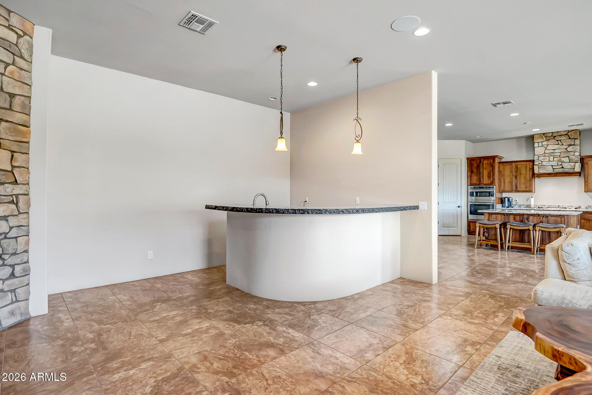 1121 East Saddle Mountain Road Phoenix, AZ 85086 - Photo 14 of 49 a view of a kitchen with kitchen island a counter top space appliances and a ceiling fan