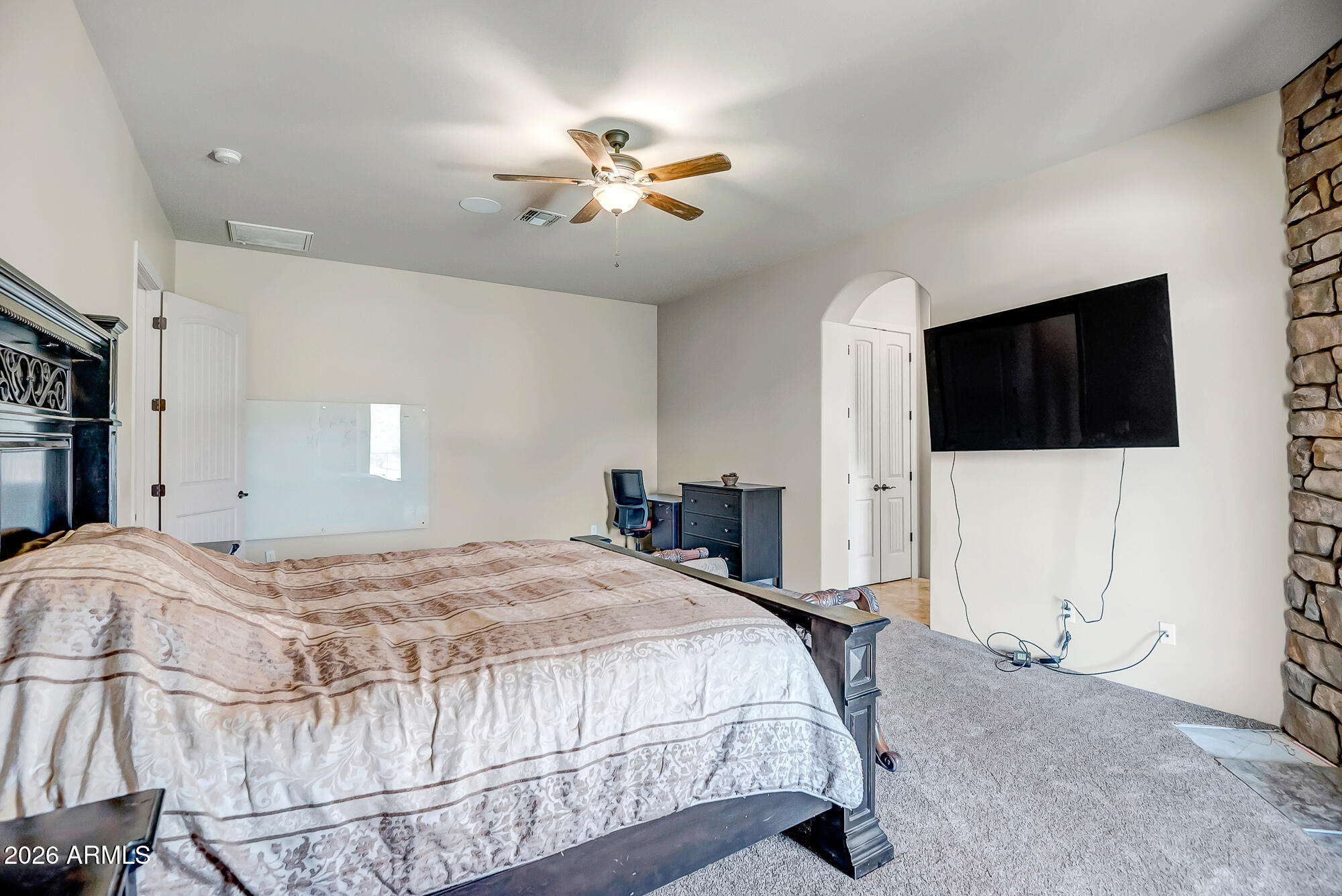 1121 East Saddle Mountain Road Phoenix, AZ 85086 - Photo 17 of 49 a bedroom with a bed and a flat screen tv