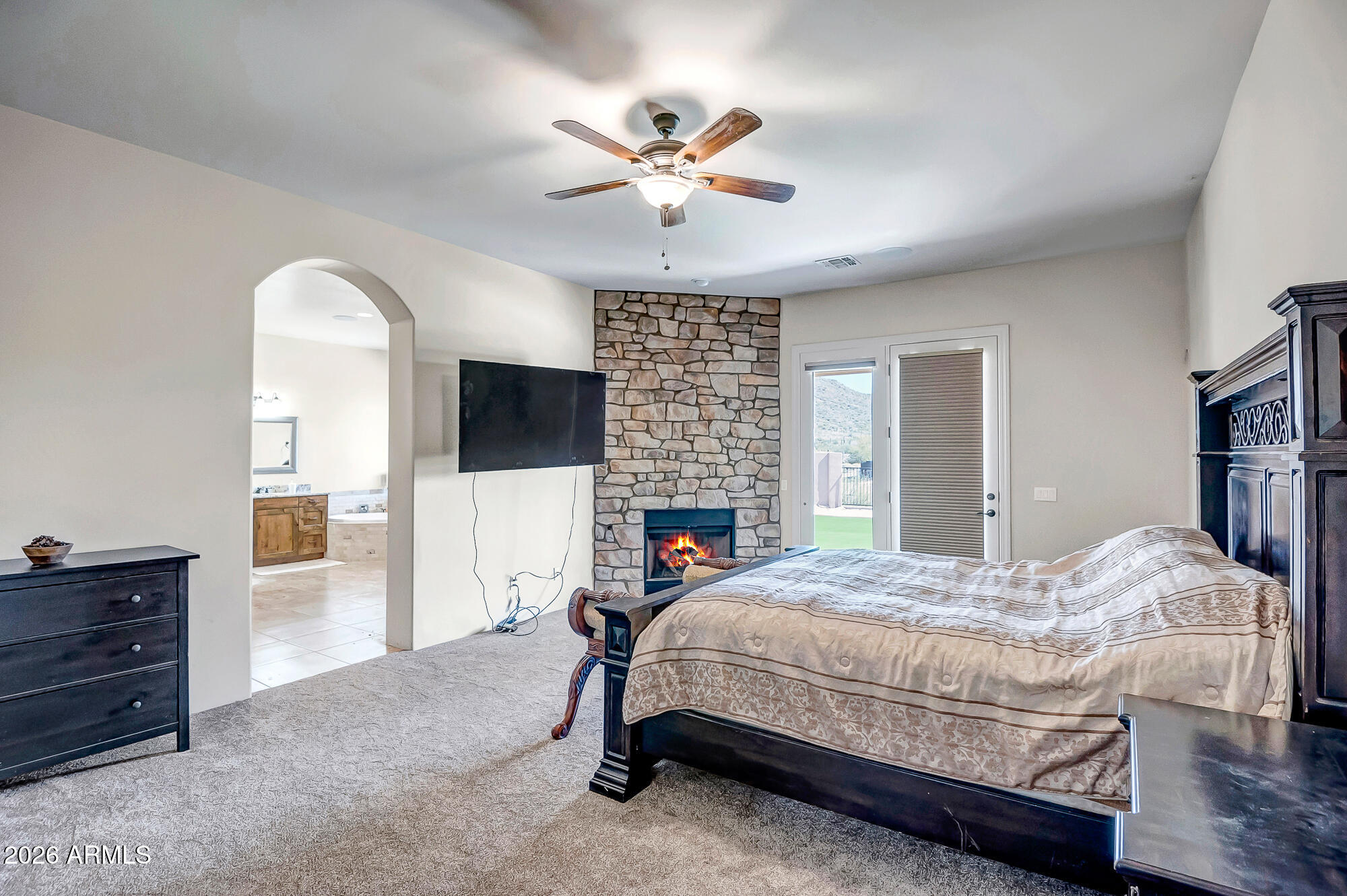 1121 East Saddle Mountain Road Phoenix, AZ 85086 - Photo 19 of 49 a bedroom with a bed and a chandelier