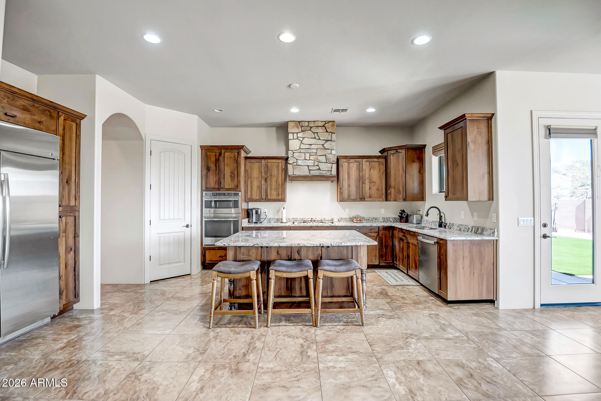 1121 East Saddle Mountain Road Phoenix, AZ 85086 - Photo 2 of 49 a kitchen with a table and chairs in it