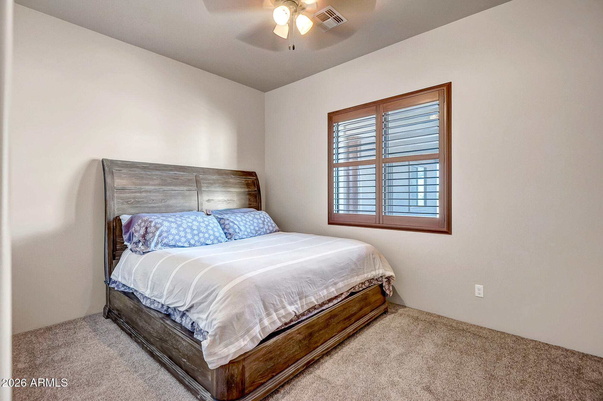 1121 East Saddle Mountain Road Phoenix, AZ 85086 - Photo 27 of 49 a bedroom with a bed and a chandelier