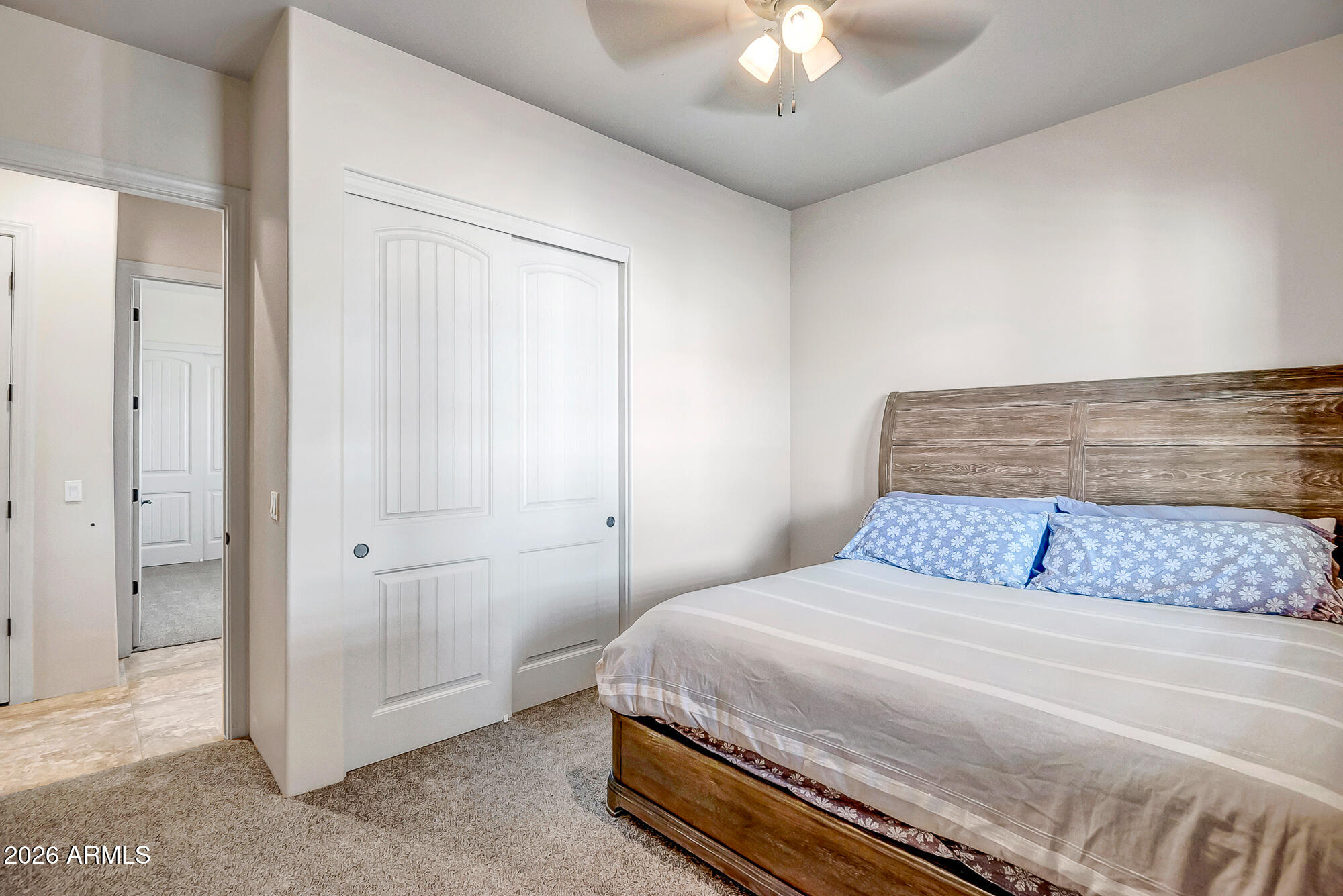 1121 East Saddle Mountain Road Phoenix, AZ 85086 - Photo 28 of 49 a bedroom with a bed and a chandelier