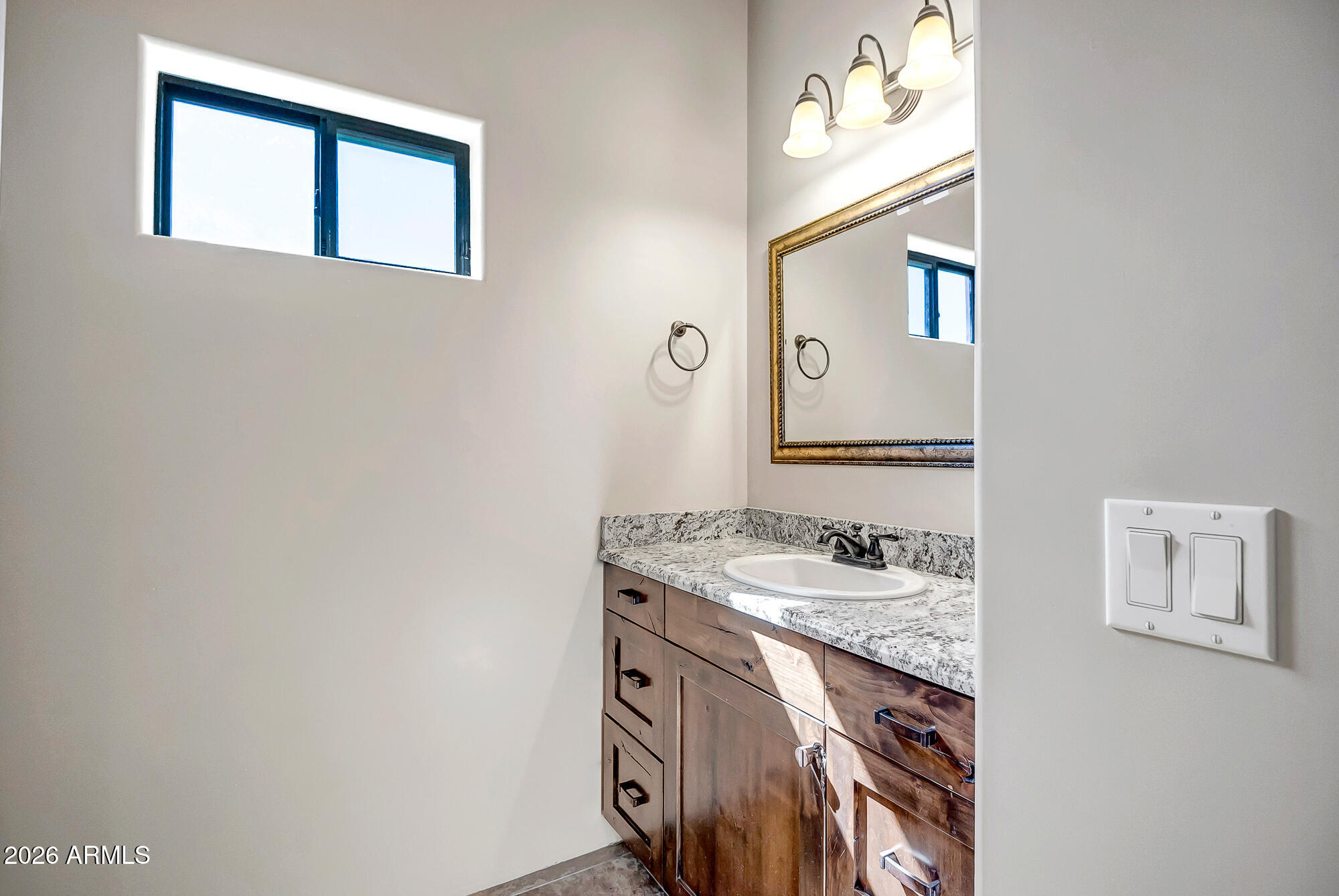 1121 East Saddle Mountain Road Phoenix, AZ 85086 - Photo 29 of 49 a bathroom with a sink and a mirror
