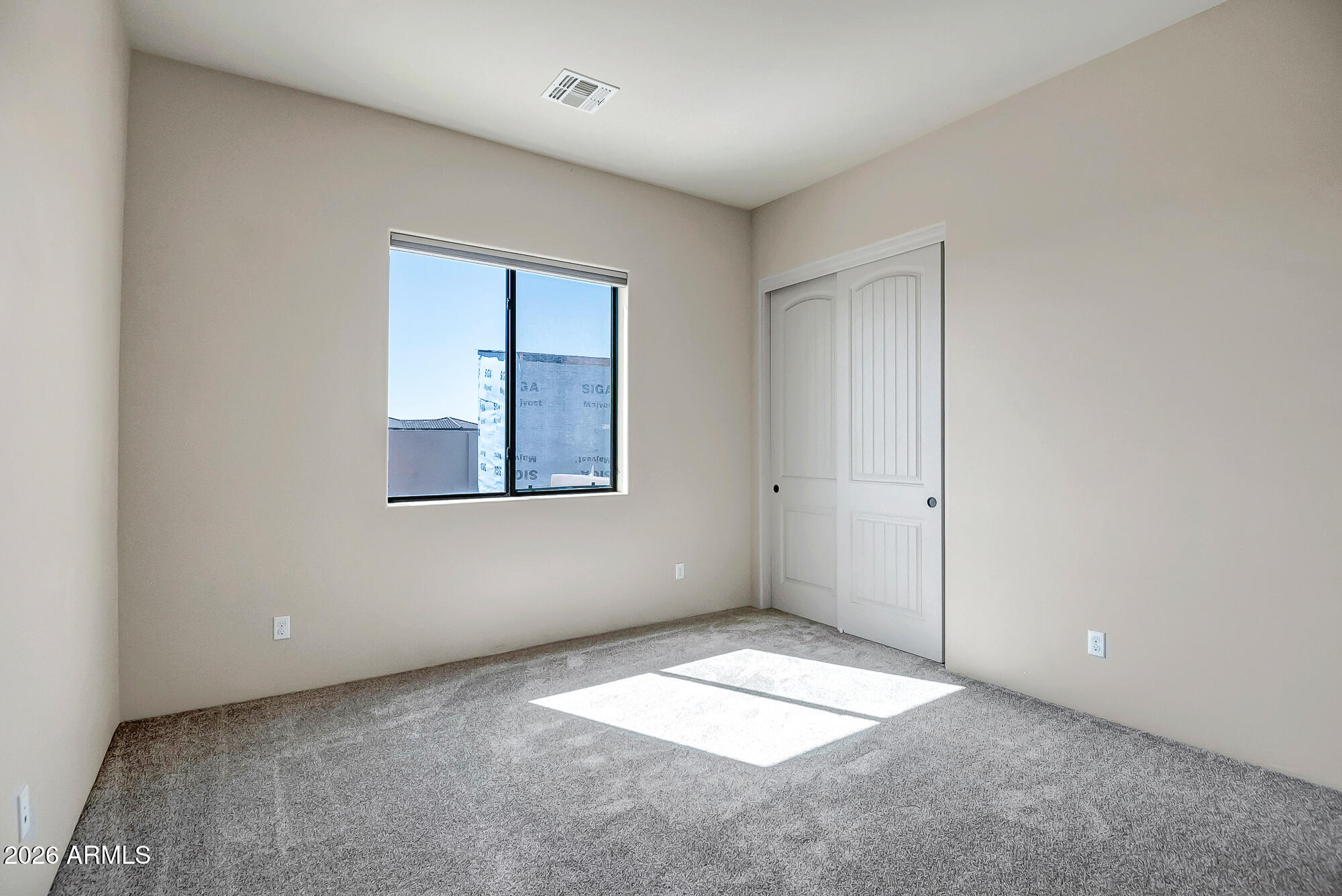 1121 East Saddle Mountain Road Phoenix, AZ 85086 - Photo 32 of 49 an empty room with a window