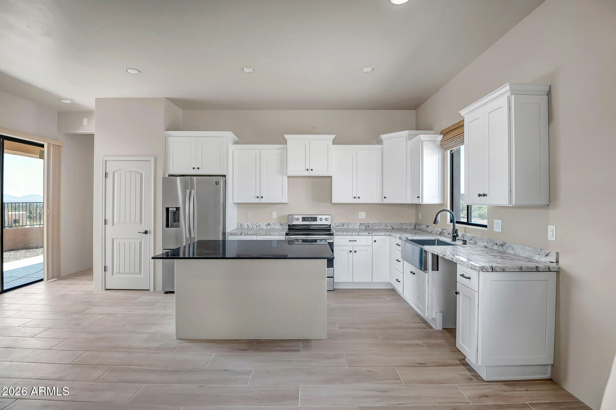 1121 East Saddle Mountain Road Phoenix, AZ 85086 - Photo 41 of 49 a large kitchen with stainless steel appliances and white cabinets