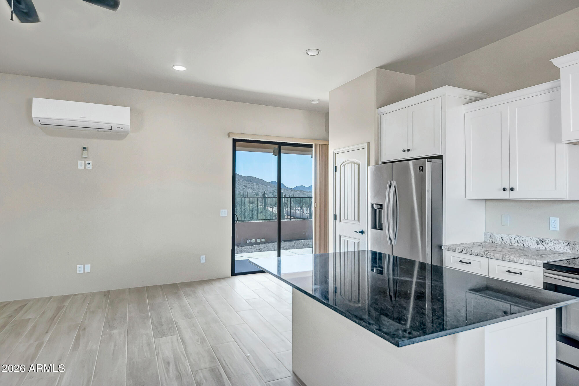 1121 East Saddle Mountain Road Phoenix, AZ 85086 - Photo 44 of 49 a kitchen with stainless steel appliances granite countertop a refrigerator a stove and white cabinets with wooden floor