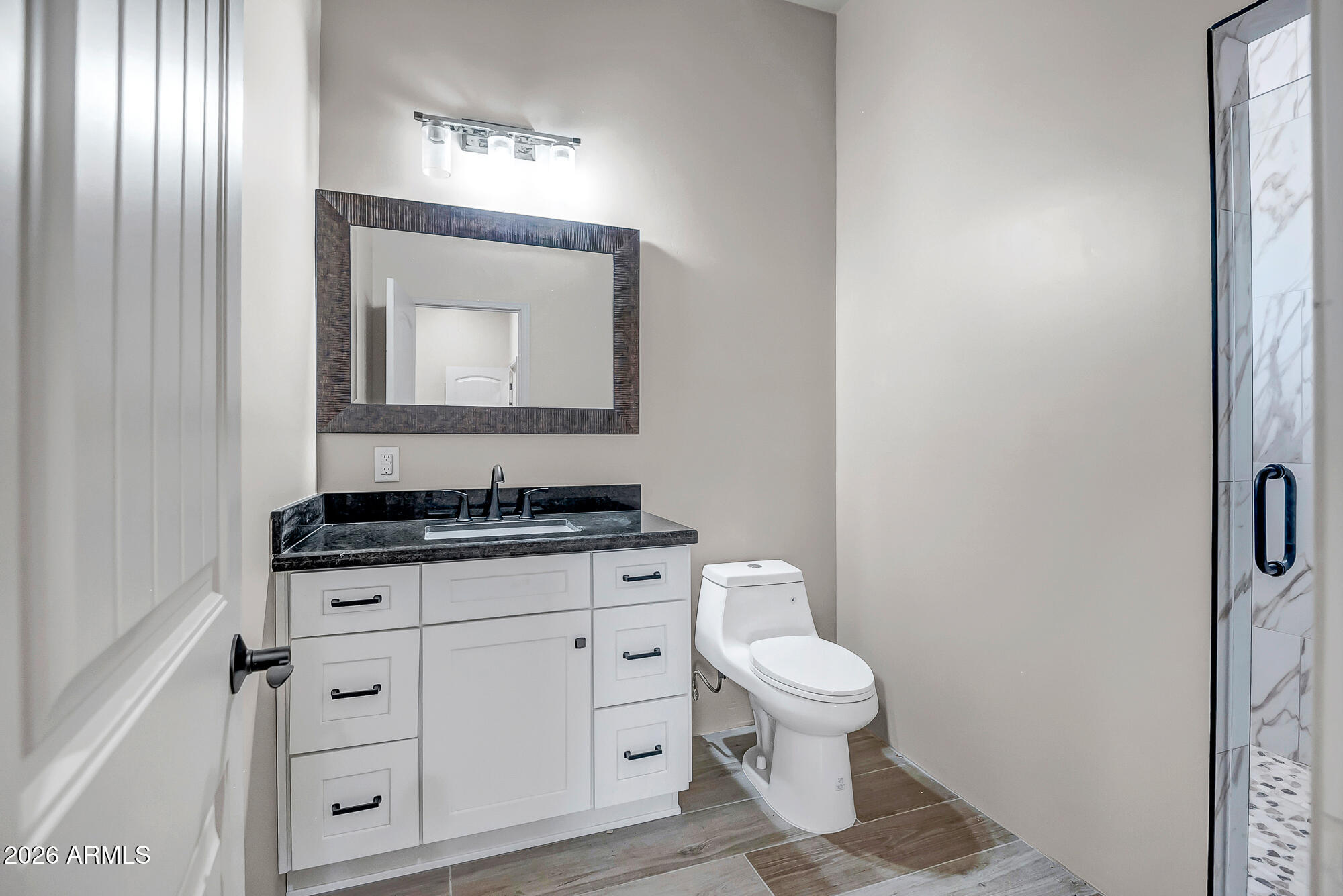 1121 East Saddle Mountain Road Phoenix, AZ 85086 - Photo 48 of 49 a bathroom with a toilet a sink and mirror